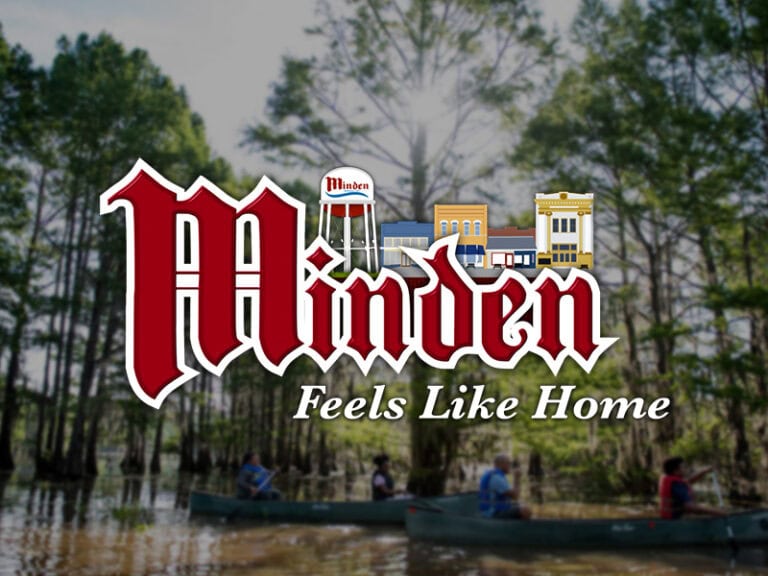 Minden, Louisiana logo with cityscape and water tower background.